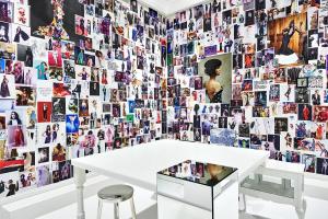 a white table in front of a wall of photos at De L’Europe Amsterdam – The Leading Hotels of the World in Amsterdam