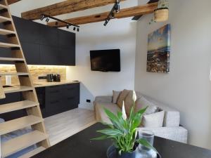 a living room with a couch and a table at Courtyard Condo Sunset in Liepāja
