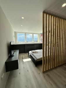 a bedroom with a bed and a desk and a window at IOS ArtPrg in Prague