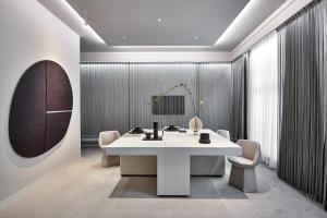 a meeting room with a white table and chairs at De L’Europe Amsterdam – The Leading Hotels of the World in Amsterdam