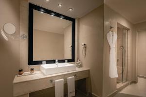 a bathroom with a sink and a mirror at Opera Plaza Hotel Marrakech in Marrakech