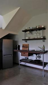 a kitchen with a table and a refrigerator at Villa La Mercy Maisonette -No load shedding or water outage in La Mercy +8 photos