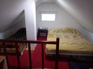a small bedroom with a bed in the attic at Jezerca Wild Beauty in Pluzine