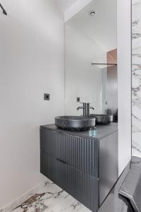 a bathroom with a sink on top of a counter at MyKeypers - Luxury Flat 3BR 8P with Jacuzzi - Haussmann in Paris