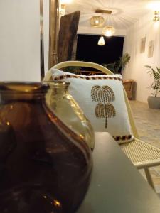 a vase sitting on a table next to a chair at Zanzicrown in Nungwi