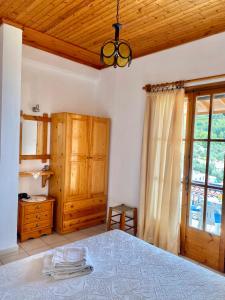 a bedroom with a bed and a wooden ceiling at Betsanis Stafylos Apartments in Stafylos