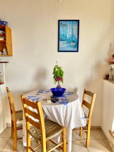 a dining room table with a blue vase on it at Betsanis Stafylos Apartments in Stafylos