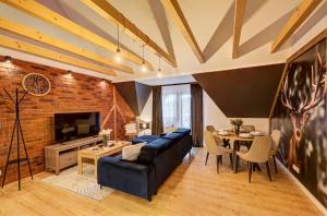 a living room with a blue couch and a brick wall at Chata u Bożeny in Muszyna