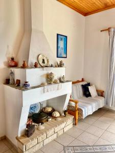a living room with a fireplace and a bed at Betsanis Stafylos Apartments in Stafylos