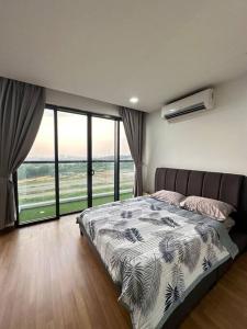 a bedroom with a bed with a view of the ocean at Sunset View Condo Cyberjaya in Cyberjaya