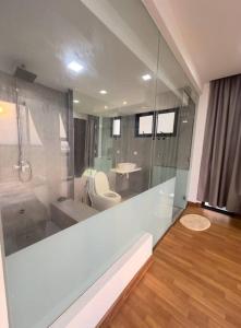 a bathroom with a shower and a toilet and a sink at Sunset View Condo Cyberjaya in Cyberjaya +18 photos