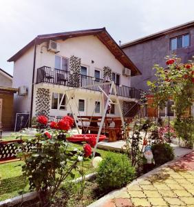 a house with a garden in front of it at Casa Georgeta 2 Mai-Punct Gastronomic Local-AROME DOBROGENE in 2 Mai