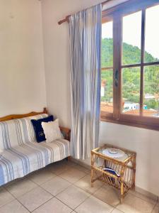 a bedroom with a bed and a window with a table at Betsanis Stafylos Apartments in Stafylos