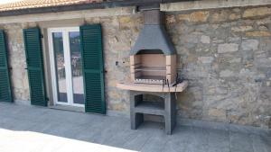 a stove on the side of a building with green shutters at vignale holiday house in La Spezia