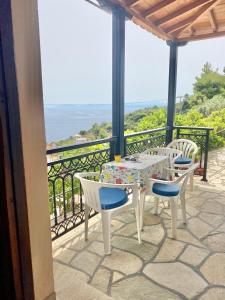 a patio with a table and chairs on a balcony at Betsanis Stafylos Apartments in Stafylos
