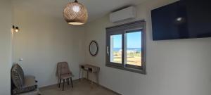 a room with a window with a view of the ocean at VAYAL SKYROS in Skiros