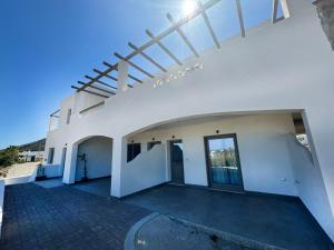a large white building with a large doorway at VAYAL SKYROS in Skiros