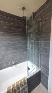 a shower with a glass door in a bathroom at The Homestay in High Wycombe +34 photos