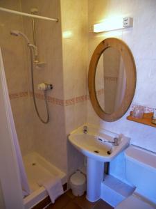 a bathroom with a sink and a shower and a mirror at Ardleigh House in Edinburgh