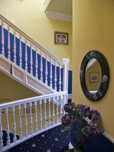 a staircase leading up to a balcony with flowers in it at Ardleigh House in Edinburgh