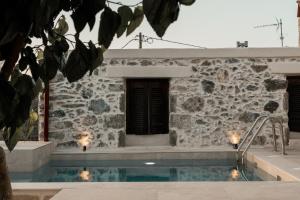 a house with a swimming pool in front of a building at Petra Serenity Home in Mourné
