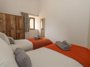 a bedroom with two beds with towels on them at Swallows Nest in Sturminster Newton