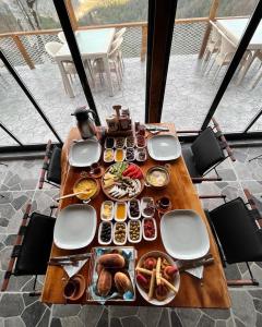 a wooden table with food on top of it at Pagen Bungalow in Hopa +36 photos