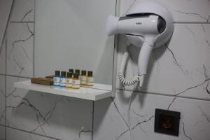 a hairdryer hanging on a wall in a bathroom at Pagen Bungalow in Hopa