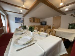 a table with plates and wine glasses on it at Holiday Home Zentral by Interhome in Schnann
