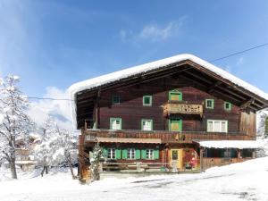 a large wooden house covered in snow at Holiday Home Geislerhütte by Interhome in Ramsau