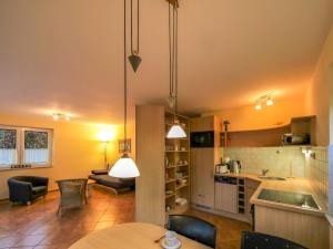 a kitchen and living room with a table and chairs at Apartment Müritz Ferienpark Röbel-14 by Interhome in Röbel +14 photos