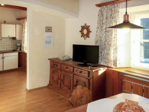 a kitchen with a television on a wooden dresser at Apartment Burg Biedenegg- Schrofenstein by Interhome in Fliess