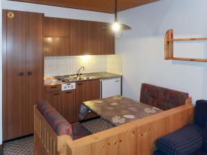 a small kitchen with a table and a sink at Studio Résidence Dixence-3 by Interhome in Les Collons