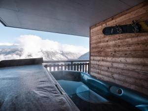 a hot tub on a balcony with a view of a mountain at Apartment Les Cîmes 4 by Interhome in Les Collons