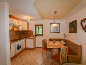 a kitchen and dining room with a table and chairs at Holiday Home Margit by Interhome in Hippach