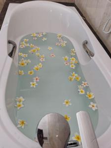 a bath tub with flowers painted on the inside of it at Aaron Hotel in Vientiane