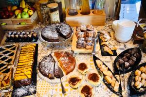 a table topped with lots of different types of pastries at Hotel Miramare - SPA & Suites - Breakfast & Brunch Until 13-00 in Cervia