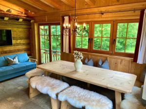 a living room with a wooden table and a couch at Apartment Sonneck by Interhome in Ramsau im Zillertal