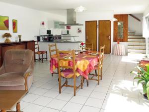 a kitchen and dining room with a table and chairs at Holiday Home Ty Kerzo by Interhome in Plouhinec