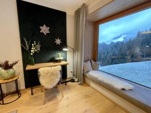a room with a window with a table and a bench at Apartment Panorama Chalet Tirol by Interhome in Auffach +65 photos