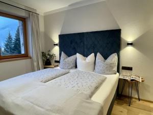 a large white bed in a room with a window at Apartment Panorama Chalet Tirol by Interhome in Auffach