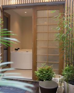a bathroom with a tub in a room with plants at Hotel Litteraire Le Swann, BW Premier Collection in Paris