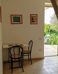 a table and chairs in a room with a patio at Agriturismo Donna Clementina in Castellaneta Marina