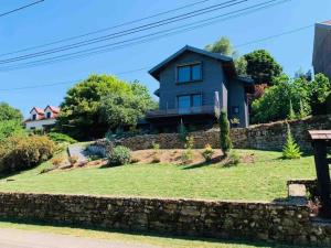 a house on a hill with a stone wall at gite du château in Montfaucon +10 photos
