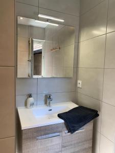 a bathroom with a sink and a mirror at Appartement Les Vendanges Parking privé Gites1596 in Beblenheim +15 photos