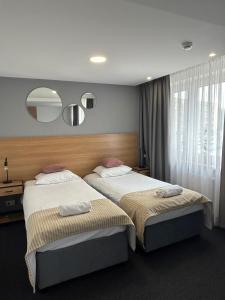 Łóżko lub łóżka w pokoju w obiekcie Gold Hotel
