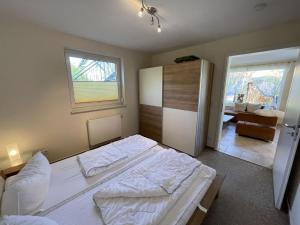 a bedroom with a large bed and a window at Apartment Müritz Ferienpark Röbel-15 by Interhome in Röbel