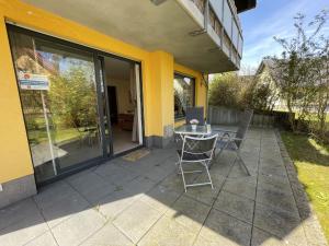 a patio with two chairs and a table in front of a building at Apartment Müritz Ferienpark Röbel-15 by Interhome in Röbel