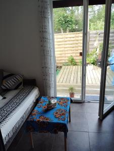 a room with a bed and a table and a sliding glass door at Studio chaleureux sans-visà-vis in Vernon