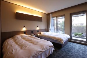 Postel nebo postele na pokoji v ubytování Miyahama Grand Hotel